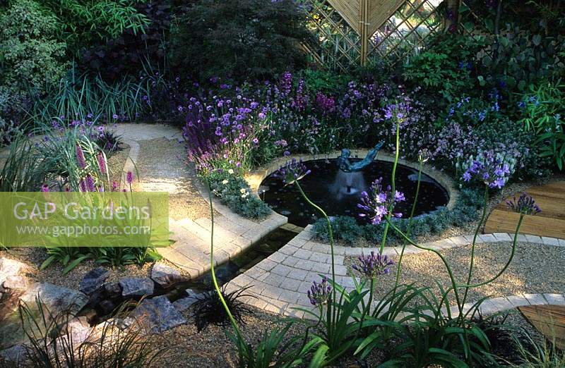 feng shui garden design Pamela Woods formal circular pool with sculptural fountian winding path and cool colour planting