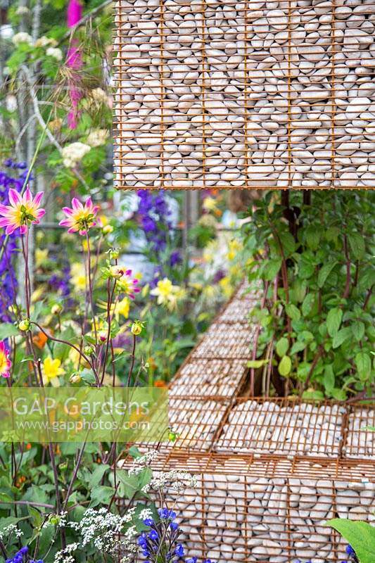 Detail of gabions used as planters in The Montessori Centenary Children's Garden at RHS Chelsea Flower Show 2019. Design: Jody Lidgard. Sponsors: Montessori Centre International 
