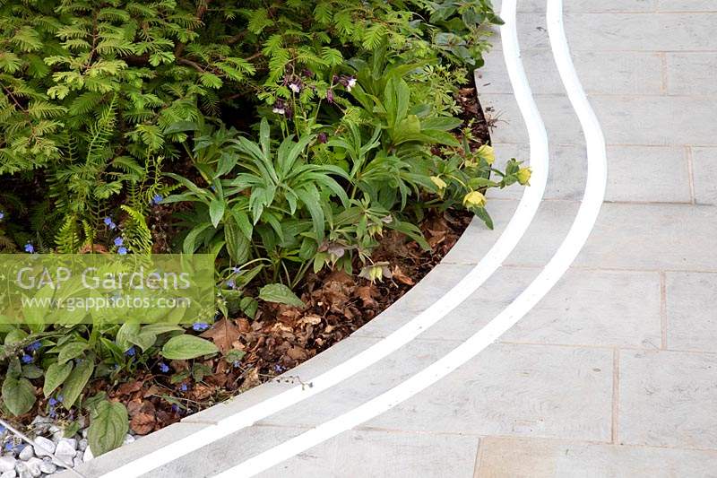 The Manchester Garden, view of subtle sinuous double rill following the course of the paving stones - Designer: Exterior Architecture, exteriorarchitecture.com. RHS Chelsea Flower Show 2019