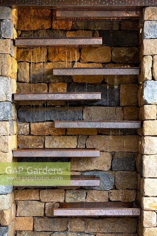 The Warners Distillery Garden, dry stone chimney with internal water feature of copper fins designed by Andy Ewinź  - Designer: Helen Elks-Smith - Construction: Bowles and Wyer - Sponsor: Warners Gin. 