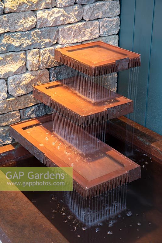 The Warners Distillery Garden, layered copper water feature with evening lighting - Design: Helen Elks-Smith - Construction: Bowles and Wyer - Sponsor: Warners Gin. 