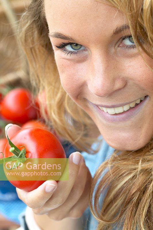 Woman holding tomato