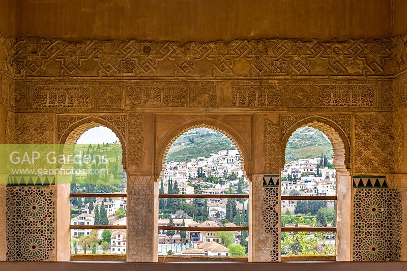 View from Palacio del Partal through ornate archways, The Alhambra, Granada.