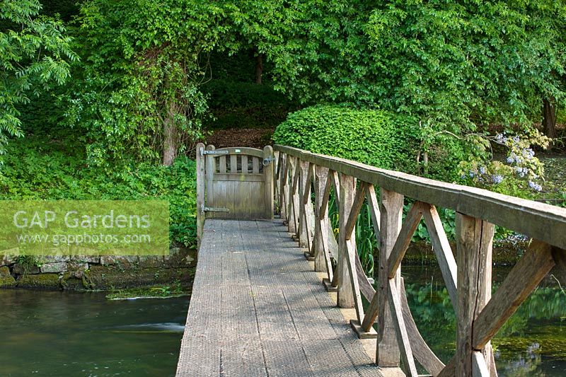 Wooden footbridge and gate over River Coln, Ablington Manor, Gloucestershire