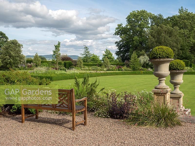 The bench is placed on the gravel patio and gives a view across the formal garden to the surrounding Herefordshire hills.