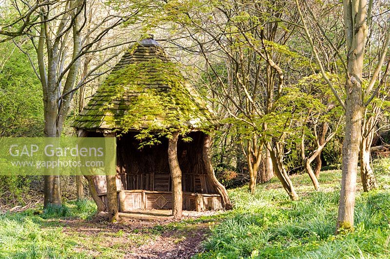 Rustic summerhouse at one end of the valley garden. Brilley Court Farm, Whitney-on-Wye, Herefordshire