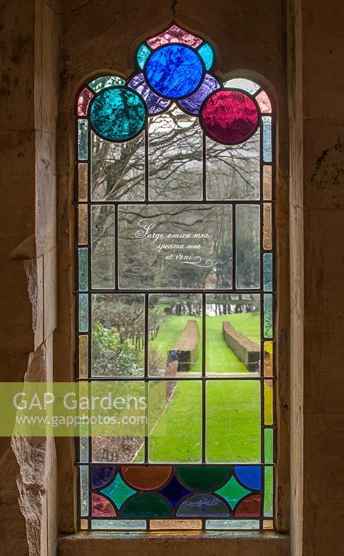 View through stained glass window to the garden

