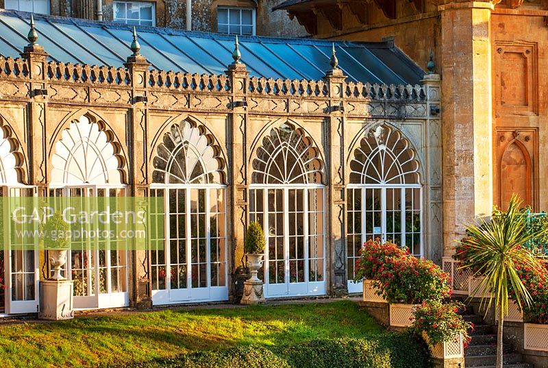 Orangery at Sezincote, Gloucestershire, with containers of fuchsias outside in morning light. 