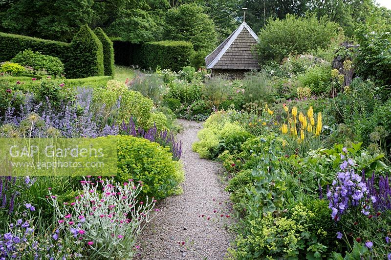 Path through deep summer borders, Arts and Crafts garden, Herefordshire.  