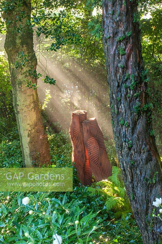 Wooden sculpture in woodland made from felled Wellingtonia 
