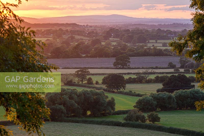 View at sunset to Abberly Hills and countryside from West Garden Terrace, Morton Hall Gardens, Worcestershire
