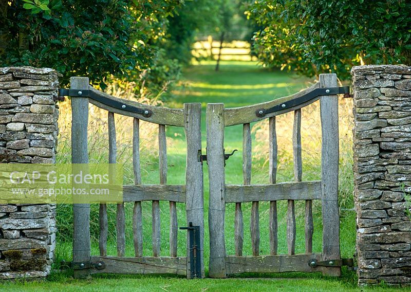 Oak cleft gate with mown grass path beyond