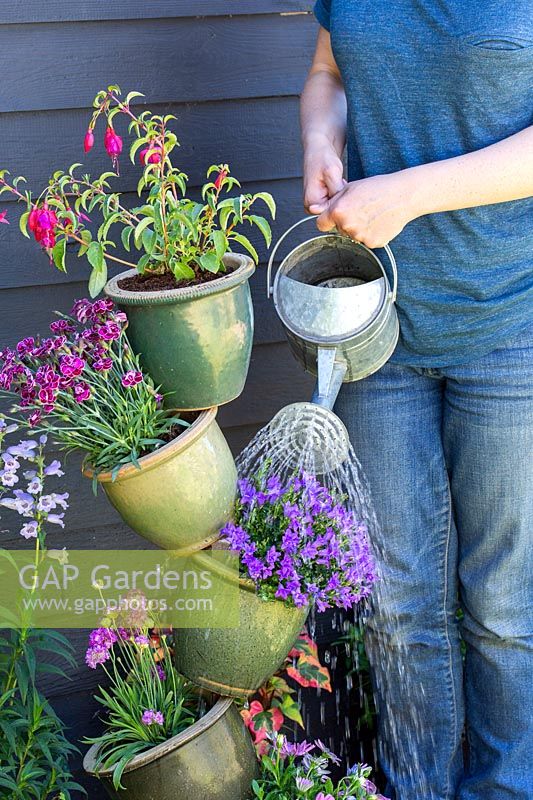 Watering ceramic pot tower with metal watering can
