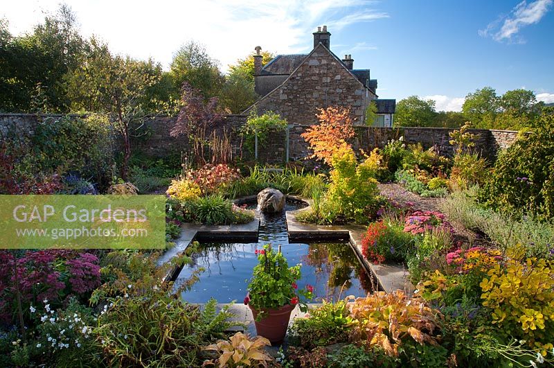 Walled garden featuring mirror pool and autumn colour.