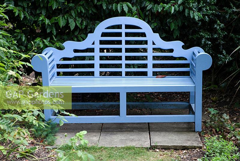 Blue-painted Lutyens-style wooden seat.
