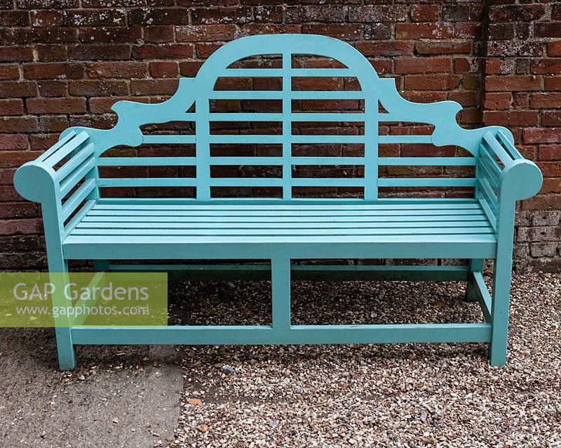 Turquoise-painted Lutyens-style wooden seat.