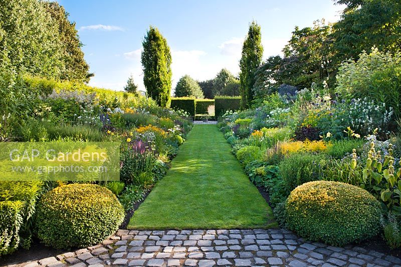 Long garden room with double mixed borders and lawn path, Laura Dingemans garden, Netherlands. 