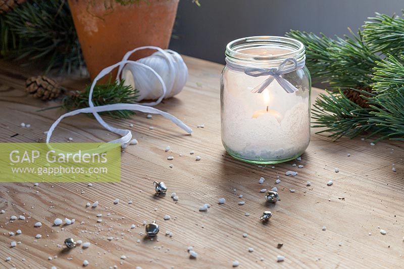 Close up detail of festive salt frosted candle jar. 