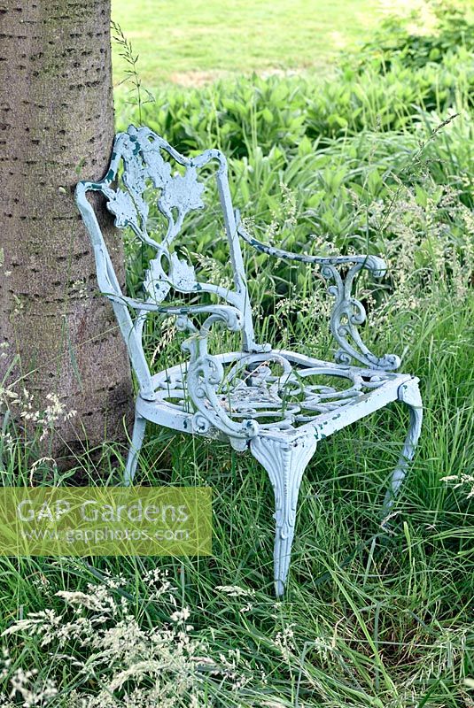 Distressed blue painted cast iron chair. 