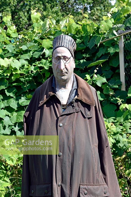 Lifelike Male scarecrow wearing waxed jacket, Golf Course Allotments, London, UK.