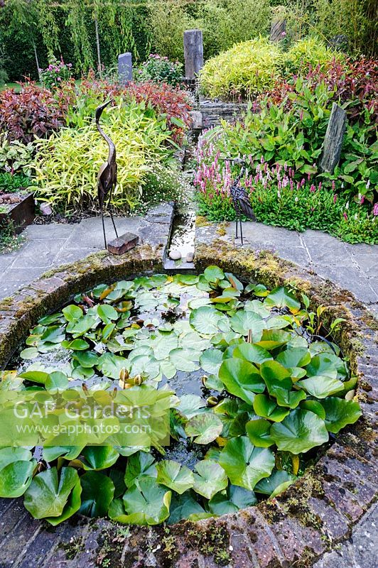 Small garden pond at Dipley Mill, Hartley Wintney, Hants, UK. 