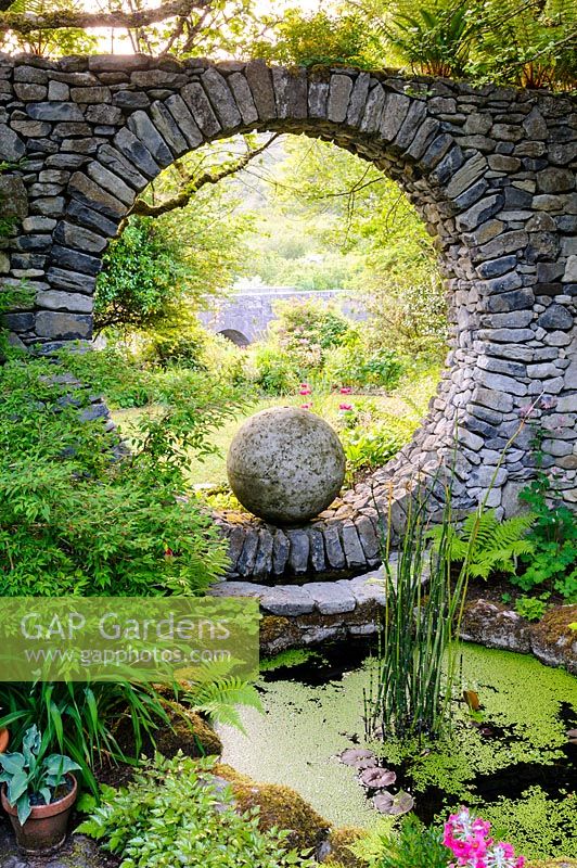 Moon Window in stone wall with circular pool. Fanore, Ireland