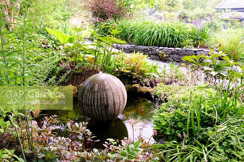 Cast concrete spherical water feature in pond. Fanore, Ireland