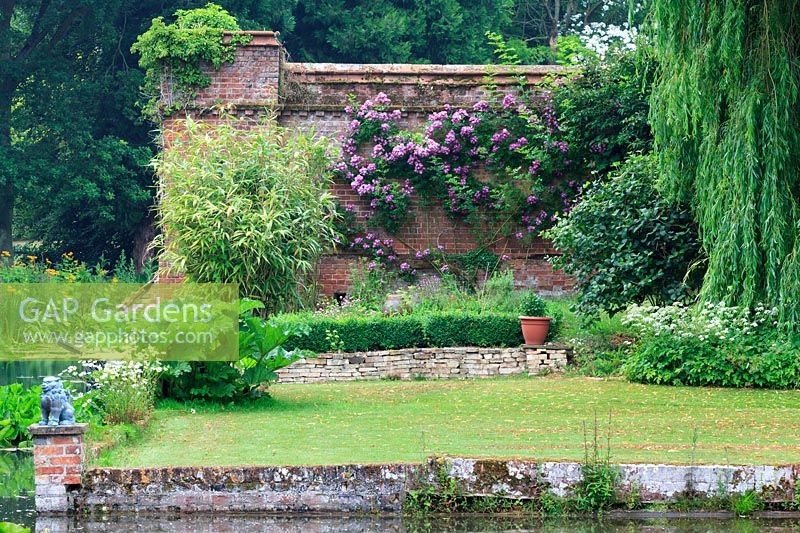 View from moat with old-fashioned roses and perennial plantings.