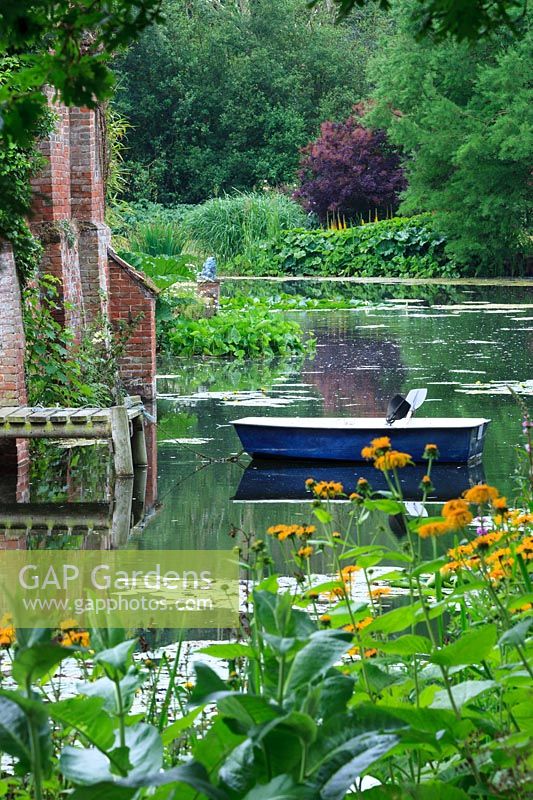 Moat with rowing boat. Inula magnifica and Lychnis - Loosestrife. 