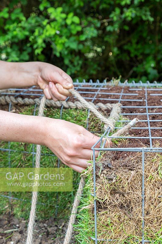 Close up detail of using rope to finish off and secure edges of gabion basket