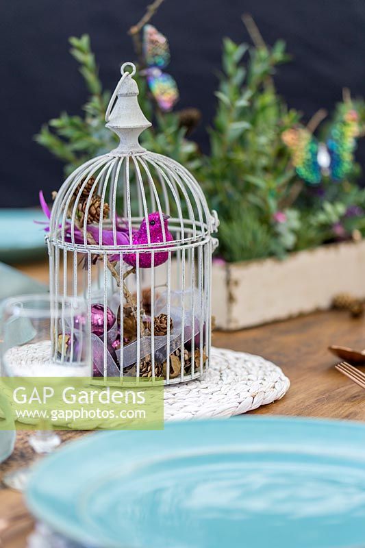 Festive bird cage themed table arrangement