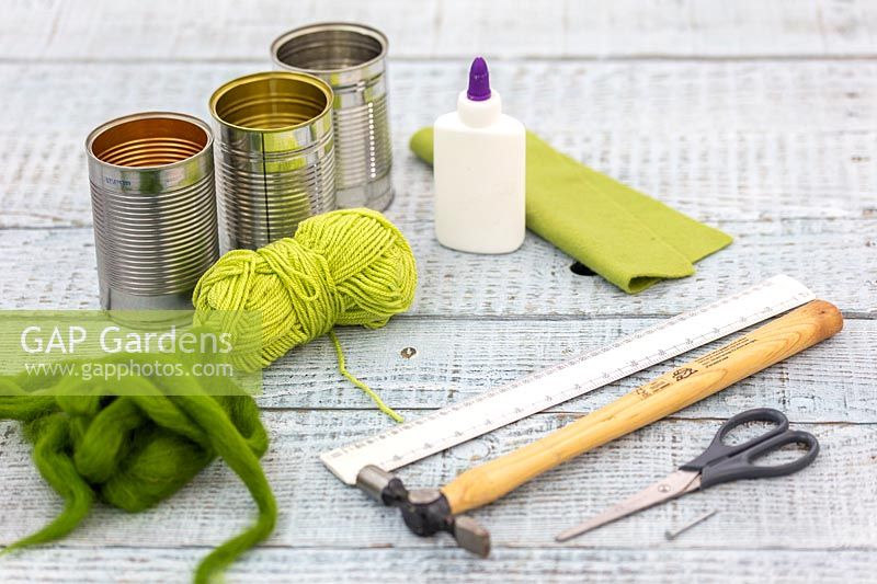 Materials and tools for creating felt decorated tin cans. 