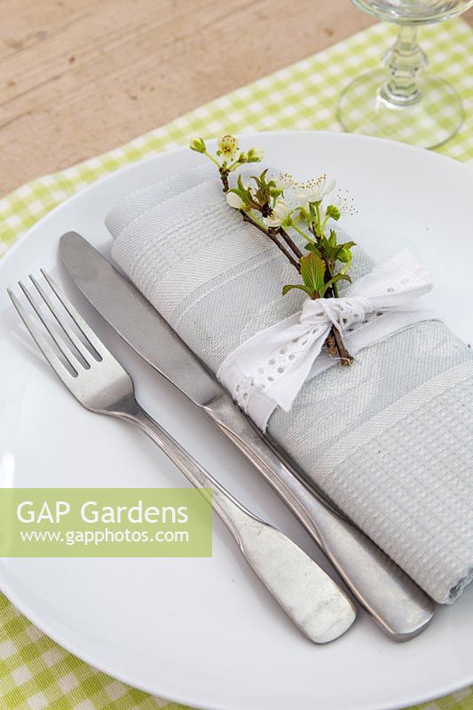 Table setting with sprig of Spring blossom and lace ribbon