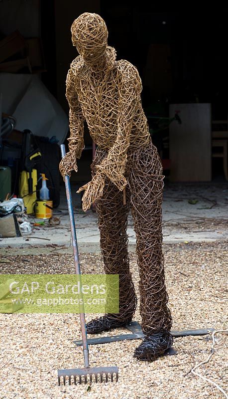 Willow Gardener scupture with a rake by Helen Colletta. Wakelins Willow, Suffolk