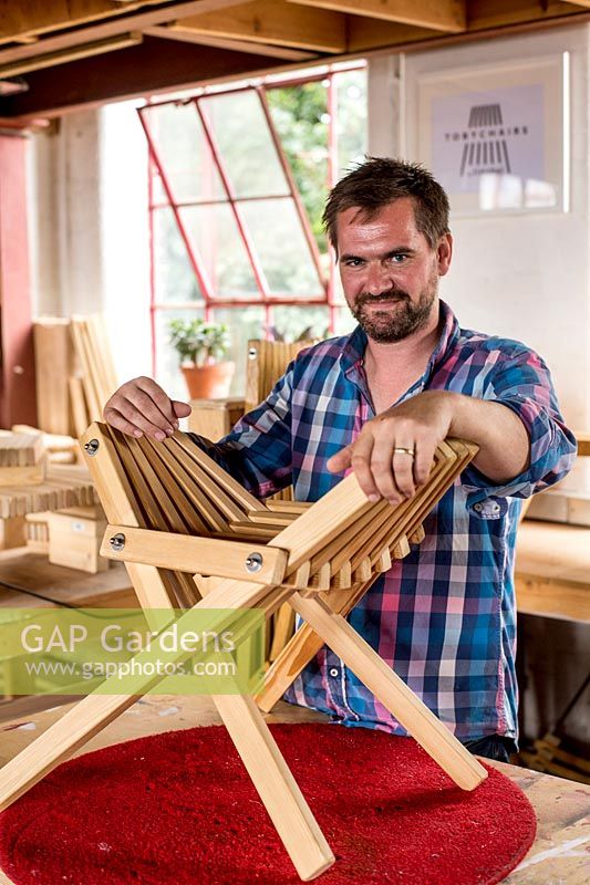 Portrait of Chris Punch, garden furniture designer, in his workshop. 