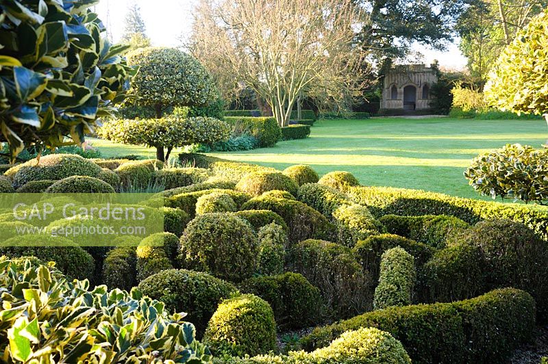 View over Undulating knot garden to lawn at Barnsley House, Cirencester, Glos, UK. 