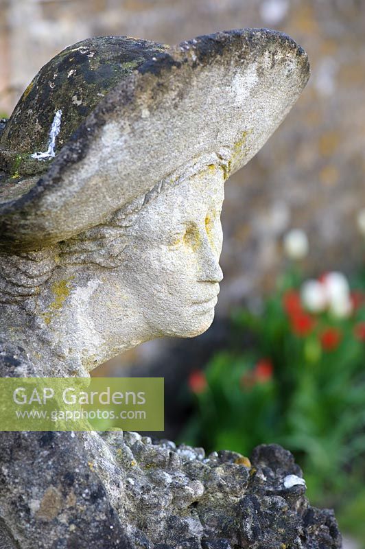 Stone carving of a woman by Simon Verity at Barnsley House, Cirencester, Glos, UK. 