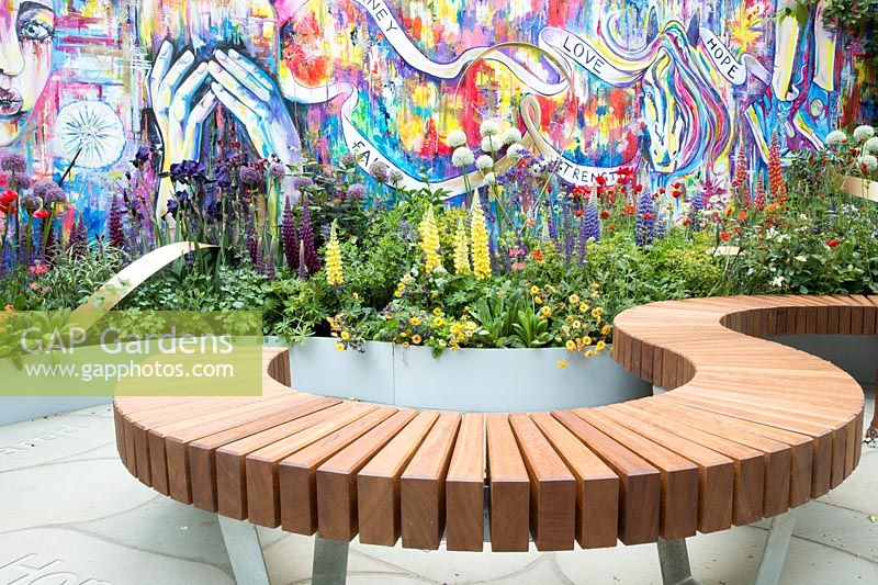 The Supershoes, Laced With Hope Garden - urban garden wall with graffiti, curved wooden bench and mixed border - RHS Chelsea Flower Show, 2018 - Sponsor: Frosts Garden Centres
