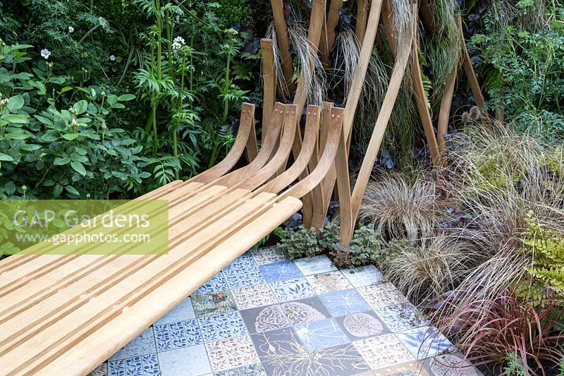 Bench by Toby Winteringham and ceramic tile path by Sue Ridge - The Embroidered Minds Epilepsy Garden - Sponsor: Embroidered Minds, Epilepsy Society and Young Epilepsy - RHS Chelsea Flower Show, 2018 