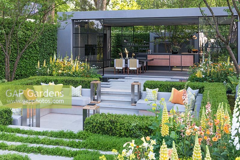 LG Eco-City Garden - Contemporary seating area with sunken courtyard, edged in beds of Lupins, Foxgloves, Aquilegia and Geum - Sponsor: LG Electronics - RHS Chelsea Flower Show 2018
