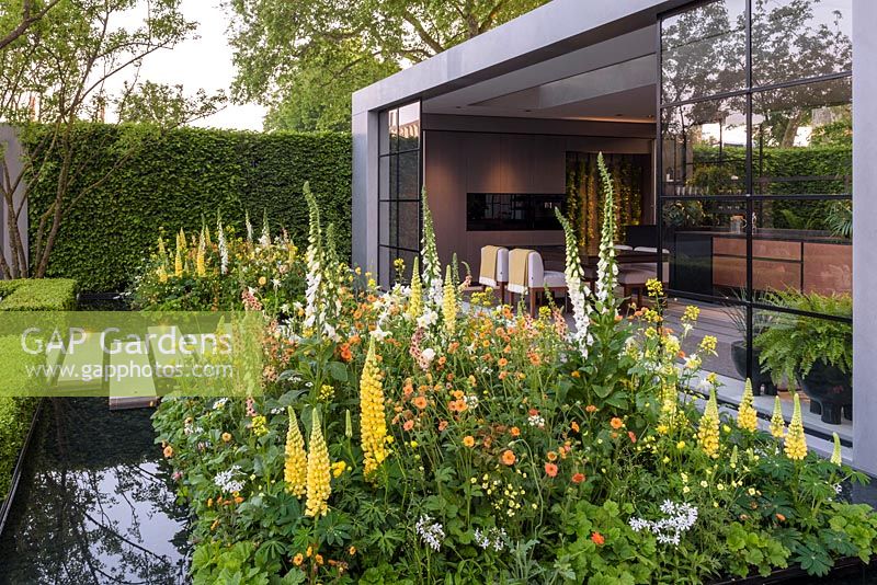 Modern pavillion with a water rill and soft planting. The LG Eco-City Garden, Sponsor LG Electronics, RHS Chelsea Flower Show, 2018.