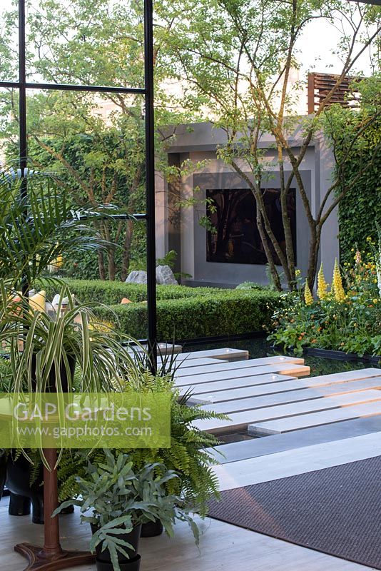 Garden pavilion with outdoor TV screen with paving over pool - The LG Eco-City Garden - Sponsor: LG Electronics - RHS Chelsea Flower Show 2018