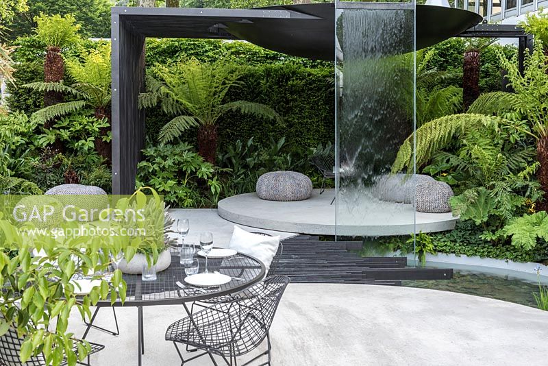 Water feature and dining area. VTB Capital Garden - Spirit of Cornwall, RHS Chelsea Flower Show, 2018. Sponsor: VTB Capital
