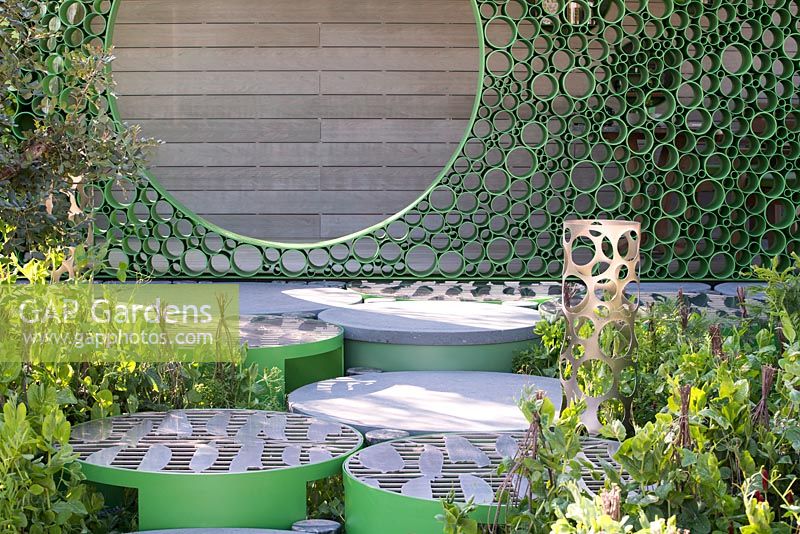 Green circular paving with Pea artwork leading to the 'Peavilion' made from aluminium tubing - The Seedlip Garden - Sponsor: Seedlip - RHS Chelsea Flower Show 2018