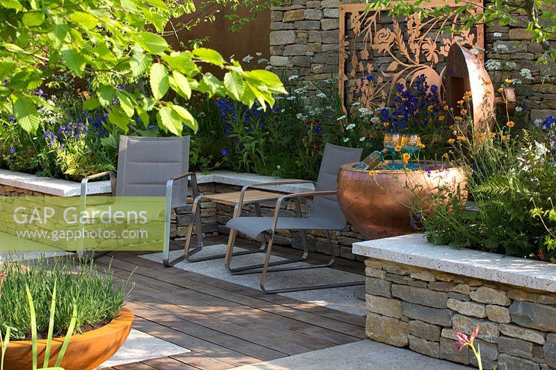 Silent Pool Gin Garden - Seating with copper pot and panel - Sponsor: Silent Pool Distillers - RHS Chelsea Flower Show 2018