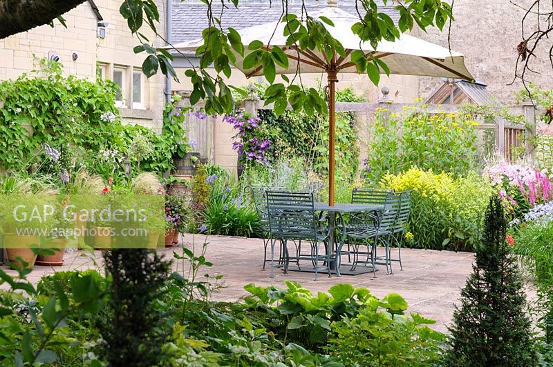 Al fresco dining with herbaceous perennials, Wiltshire, England, UK