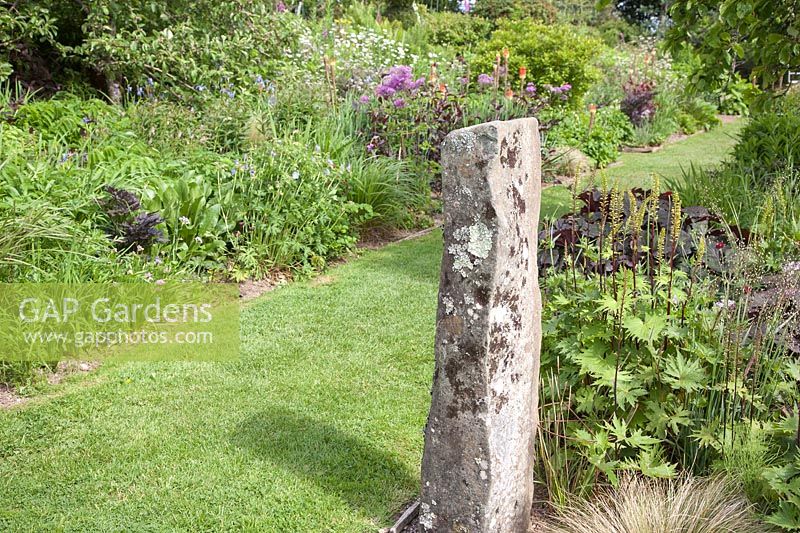 Standing stone in herbaceous, double-border at Dyffryn Fernant