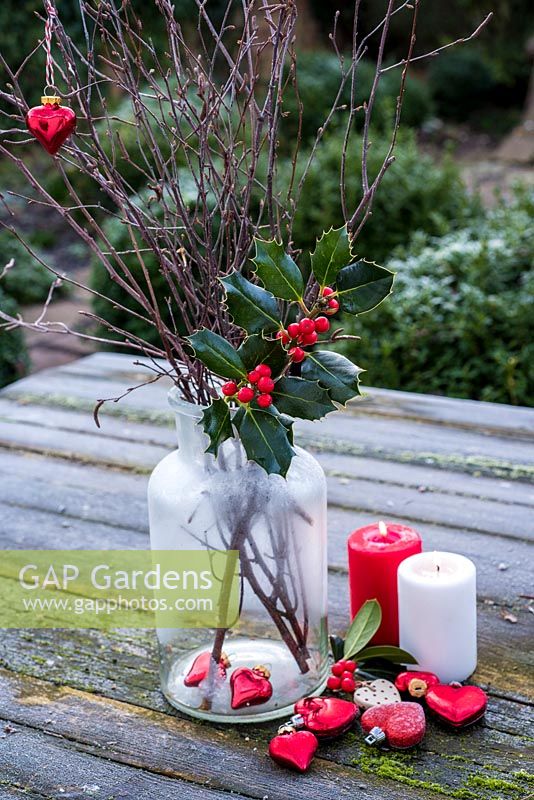 Ilex - Holly in glass jar with hearts and candles