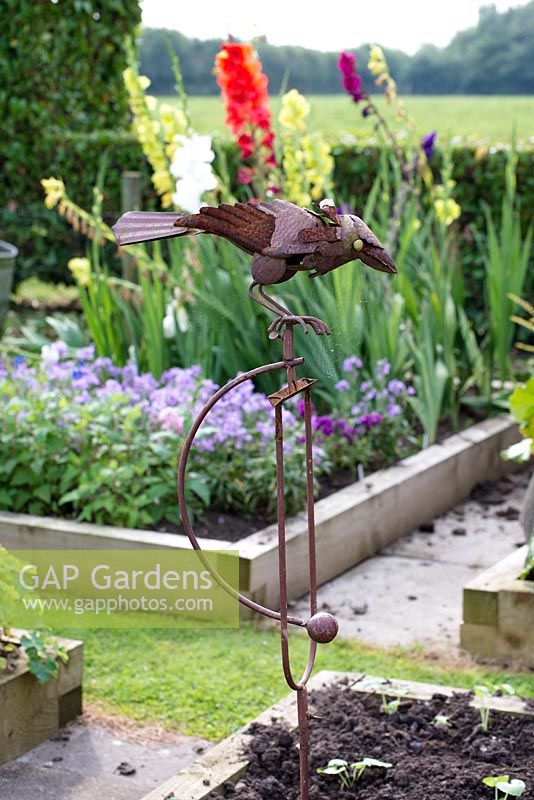 Metal crow ornament to scare off the other birds in the vegatable and cutting garden. 