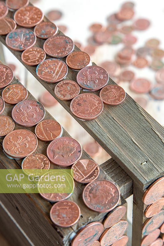 Copper coins glued to wooden box